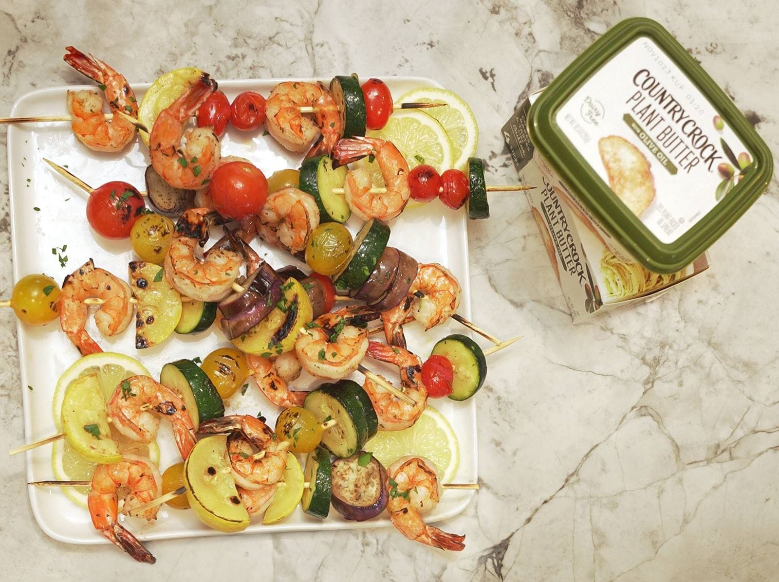 recipe image Artisanal Style Grilled Shrimp Kebabs With Fresh Vegetables And Plant Butter Drizzle