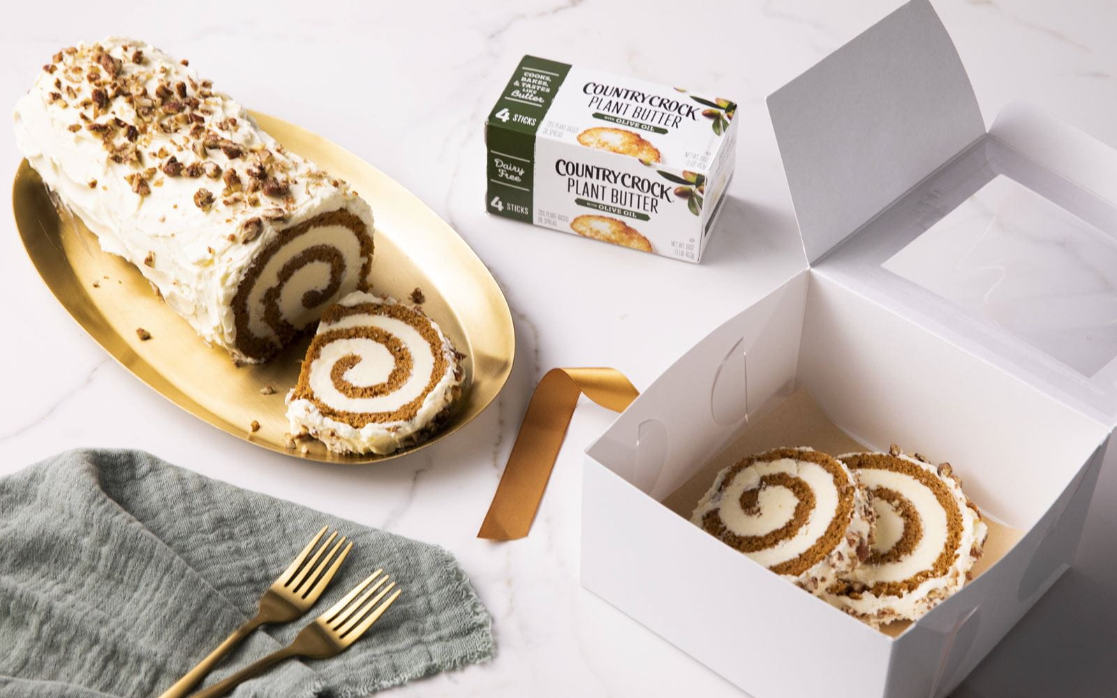 recipe image Pumpkin Spice Cake Roll with Candied Pecans and Dairy Free Cream Cheese Frosting